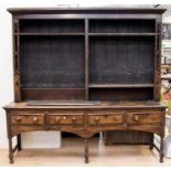 A George III oak and mahogany cross-banded dresser, the rack with removable shelves,