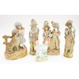 A collection of assorted bisque figures, comprising lady with a dog,