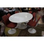 A 1950s large oval dining table on a pedestal base, together with a set of six swivelling chairs,