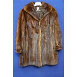 A full length Mink coat with a cowl collar,
