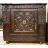 A 17th Century style oak and parquetry inlaid cupboard,