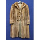 A large size beige Mink coat with six decorated bronze buttons, made by Lilian Smith of Southport,