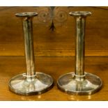 A pair of Wlaker & Hall silver candlesticks with flat circular bases, Sheffield 1934/35,
