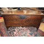 A 17th Century oak boarded chest, the front with simple incised decoration,