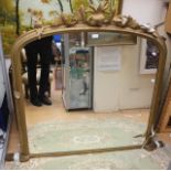 A large gold framed mirror with floral relief to top,