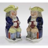 A pair of early 19th Century Staffordshire Toby jugs (one having hat lid)