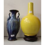 A large vase with blue mottled glaze, the twin handles formed from peacocks,