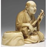 musician ivory, signed Japan 19th century Old man playing a instrument, on his knees a book with