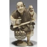 Salesman ivory, signed Japan, 20th century Standing salesman holding a scale in his hand. THIS LOT