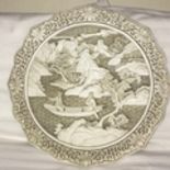 A nicely made, white cinnabar decorative plate with scroll and flower rim and a couple in a boat