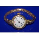 Ladies 9ct Gold Wristwatch, White Enamelled Dial, arabic Numerals, Manual Wind. Early 20thC