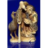 Meiji Period Stained Ivory Netsuke Depicting A Wise Man Feeding A Stork, Signed To Base