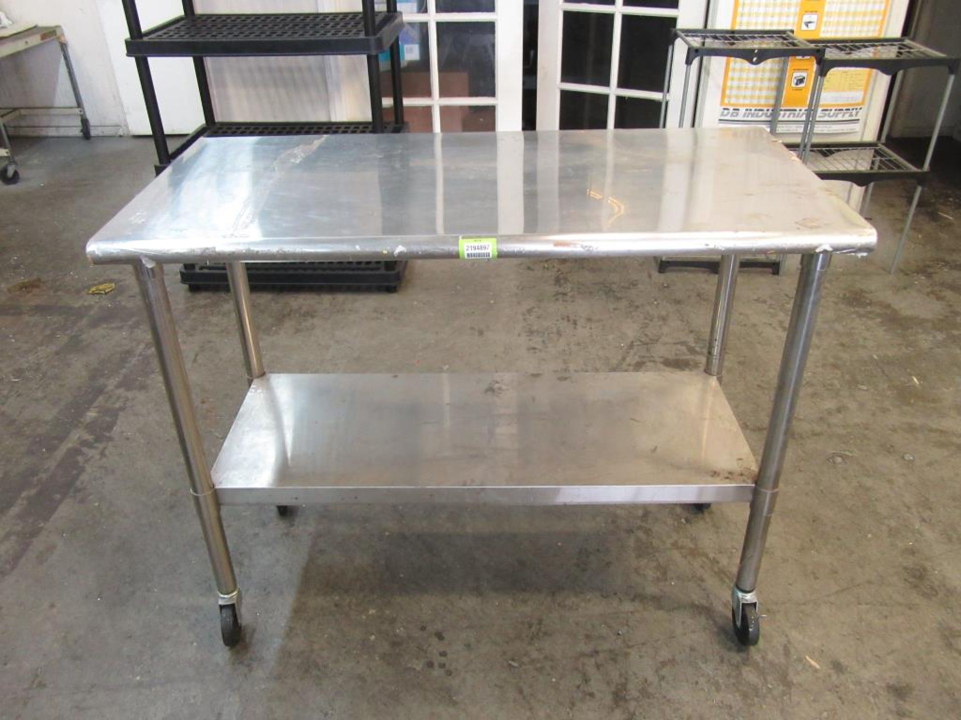 Trinity Stainless Steel Table 48"L x 38"H x 24"W with Bottom Shelf, on Casters. HIT# 2194897.