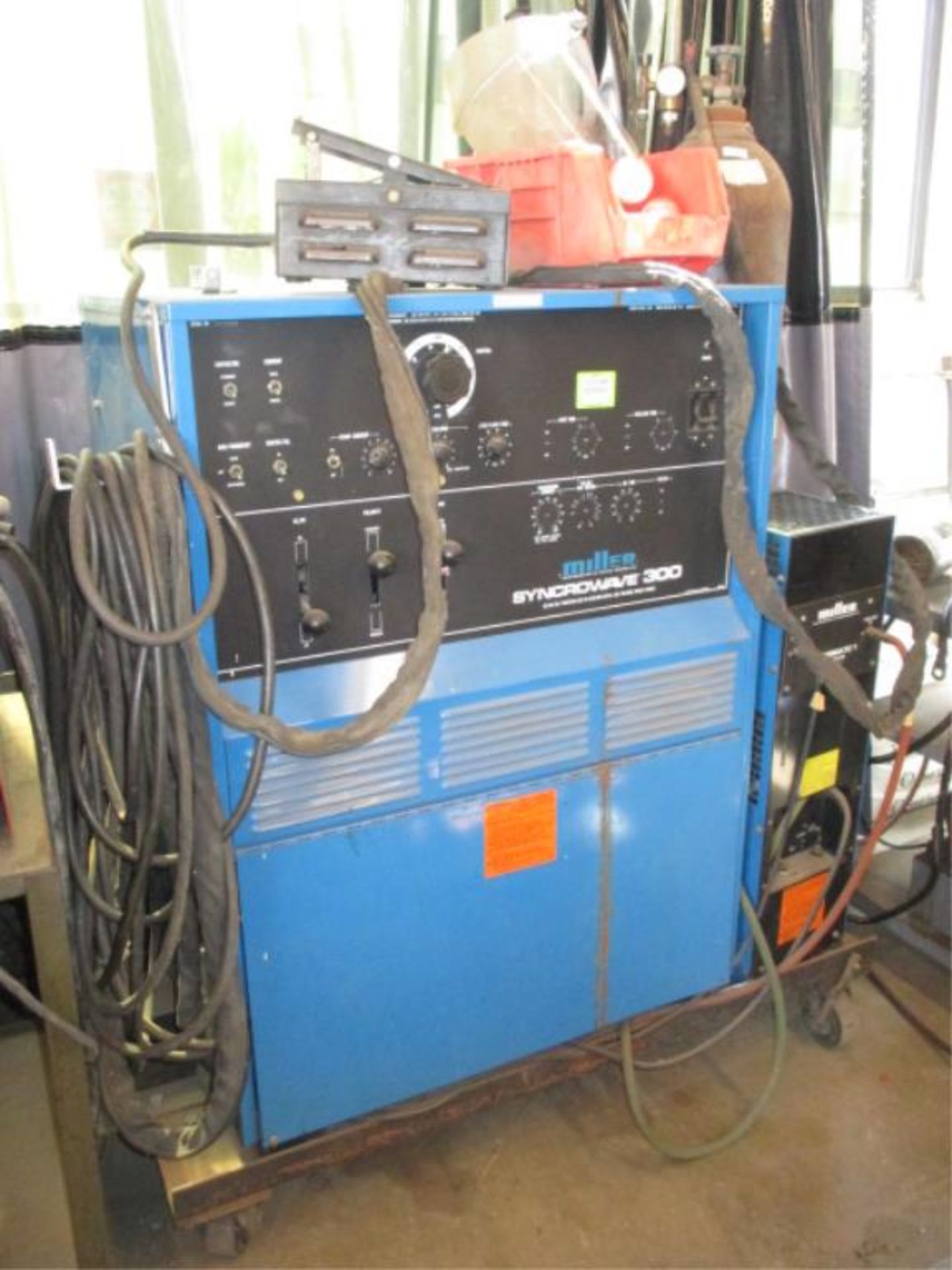 Welder. Miller Syncrowave 300 AC/DC TiG Welder with Watermate 1 Colling System and Argon Tank.