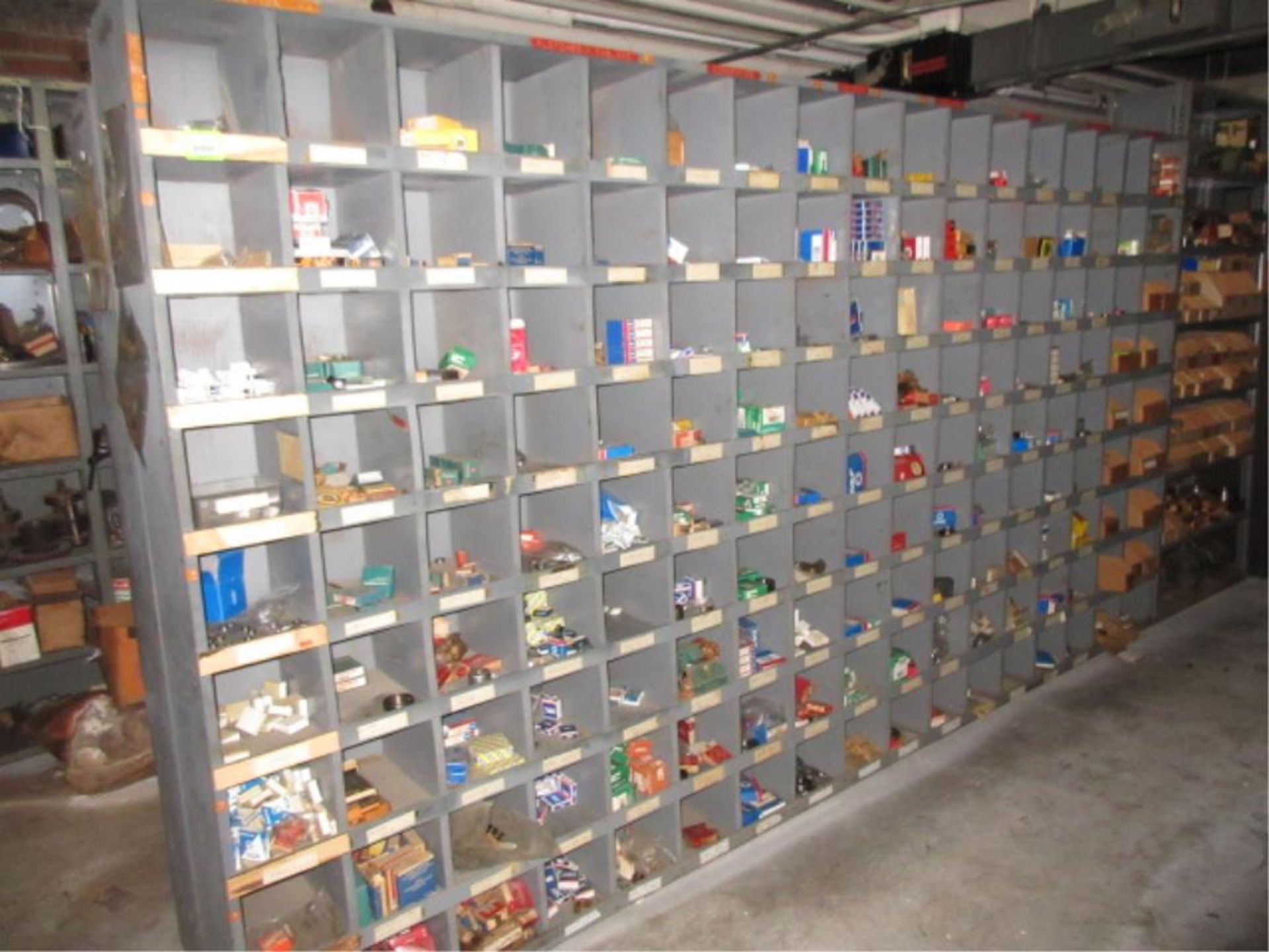 Lot Assorted Small Bearings, in one pigeon hole cabinet and one shelving unit. HIT# 2179428.
