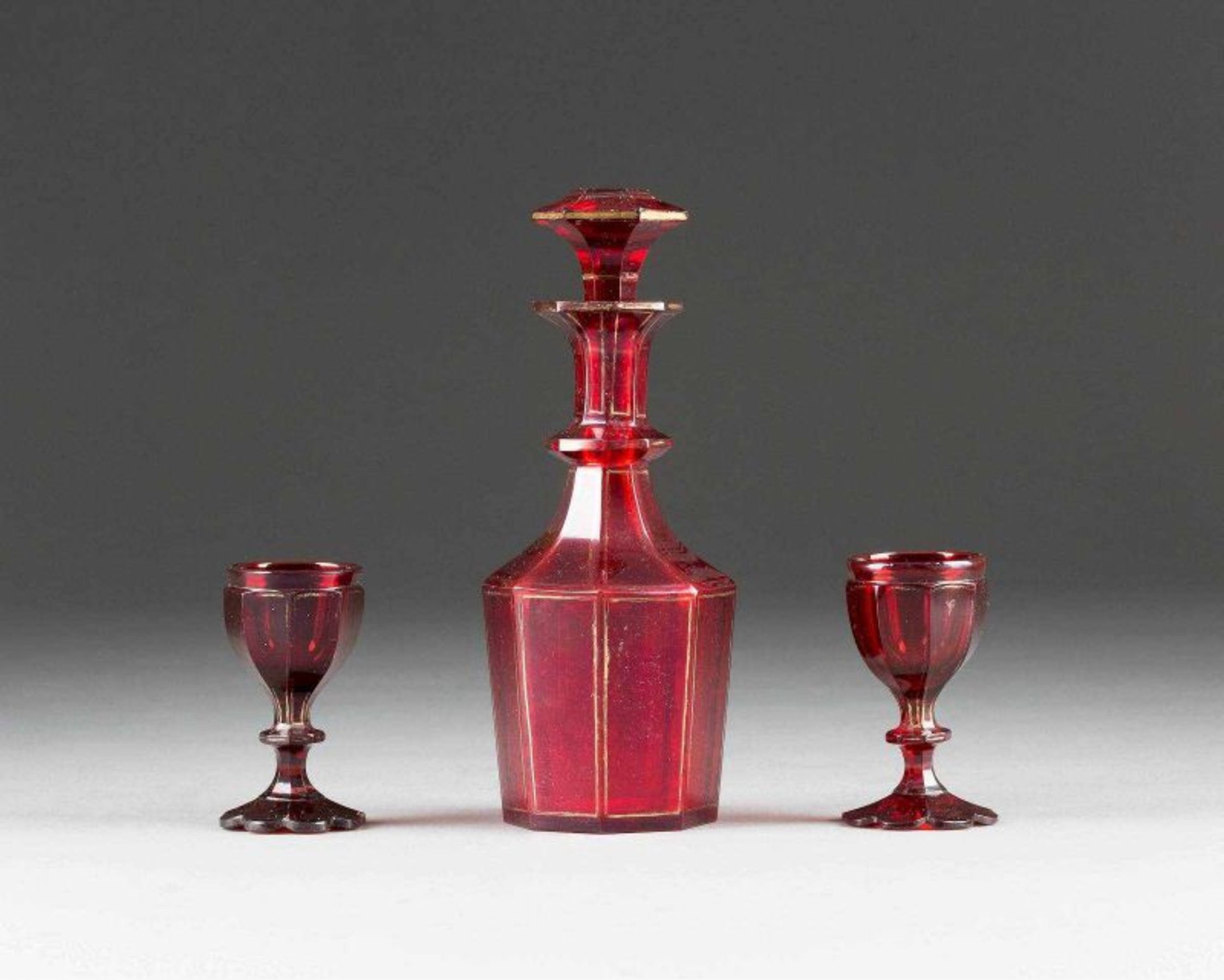 A GLASS DECANTER WITH STOPPER AND A PAIR OF BEAKERS Probably Russian, circa 1840 Colourless cut-