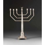 A LARGE SILVER MENORAH Probably Russian, 1864 The surface engraved with stylized foliage. Marked