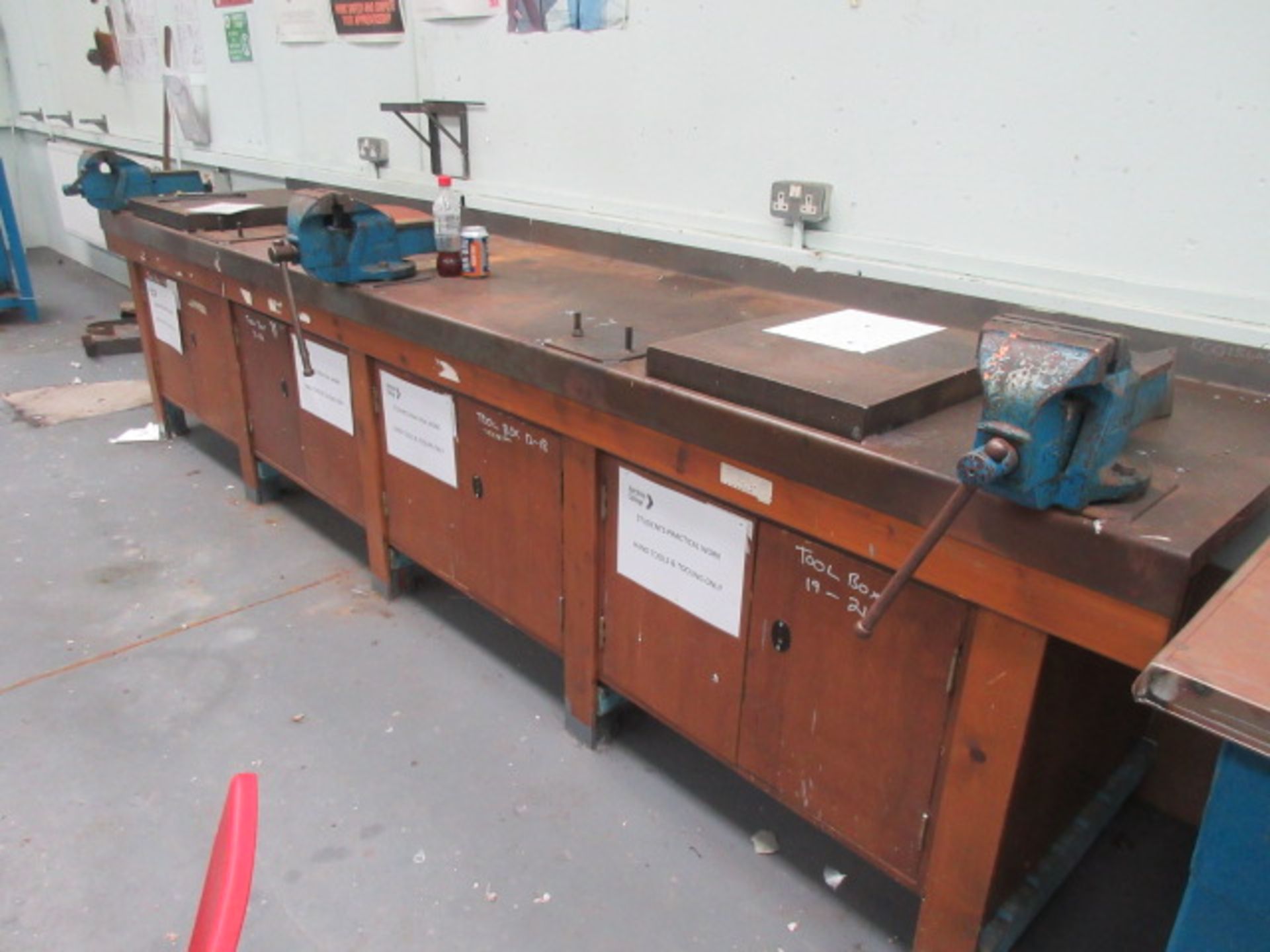 143" x 27"wooden bench with under cupboards, sheet metal top & 3 engineers vices. Holehouse Rd.