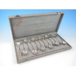 Cased set of twelve Dutch white metal teaspoons, repousse embossed with musicians,