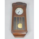 Continental oak wall clock, eight day movement, strikes on the half hour,