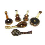 Six tortoiseshell, mother-of-pearl and ivory effect miniature musical instruments (two mandolins,