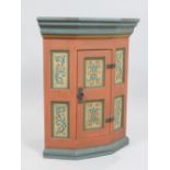 Norwegian style pine hanging corner cabinet, brick red and blue painted with six panels of flowers,