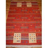 Richard Morant kelim red ground rug, to centre with geometric symbols,