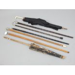 Four Victorian and later silver and white metal mounted walking sticks and canes,