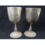 Two hallmarked silver goblets on baluster stem and circular and embossed foot, marks rubbed,