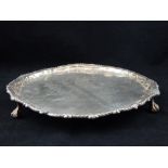Victorian hallmarked silver circular tray, bead trim, repousse scrolls to edges, ball and claw feet,