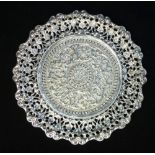 Indian white metal card tray of pierced circular form, embossed with flowerheads, 15cm dia.