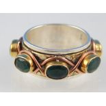 Silver spinning worry ring, lace central copper band and gilt metal set emeralds,