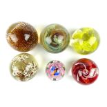 Three floral design glass paperweights and three other weights (6)