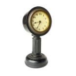 German ebonised bedside timepiece on fluted pillar and circular foot, 15cm h,