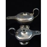 Two hallmarked silver table cigar lighters in the form of antique oil lamps, largest 9.