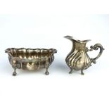 Italian silver cream jug, with spiral embossed body, together with a similar oval silver sugar bowl.