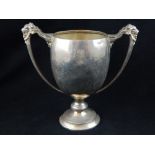 Yachting hallmarked silver trophy cup, cast iron mask strap handles on knop and socle, London 1928,