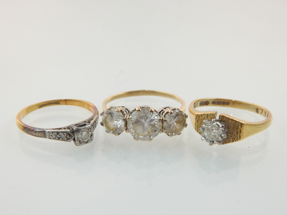 A 9ct gold and diamond ring sold together with two other 9ct gold and white stone rings.
