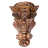 18th century and later carved oak wall bracket, incorporating cherubs and and a Corinthian terminal,