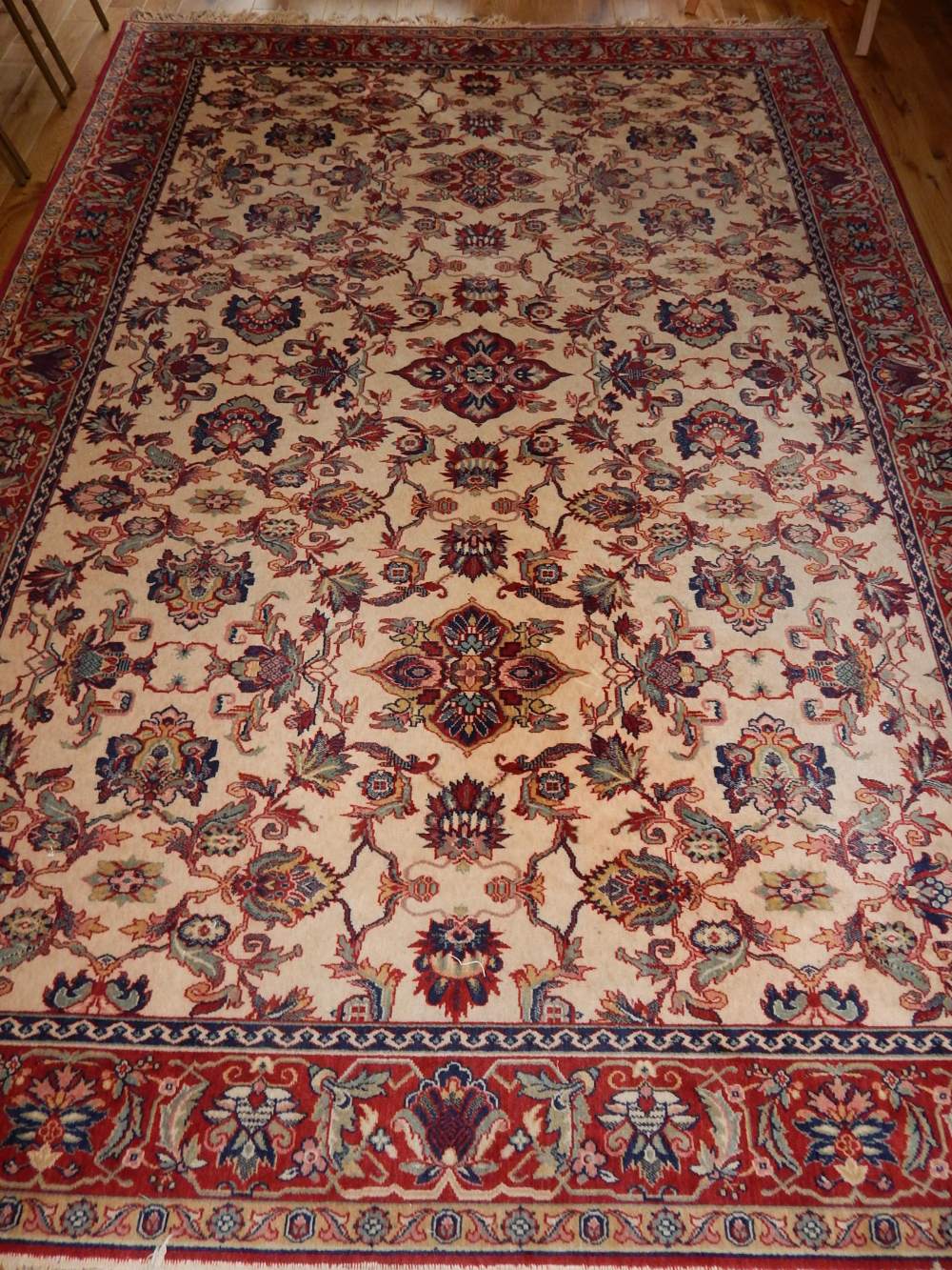 Tabriz style ivory ground carpet, the floral design field within a conforming border,