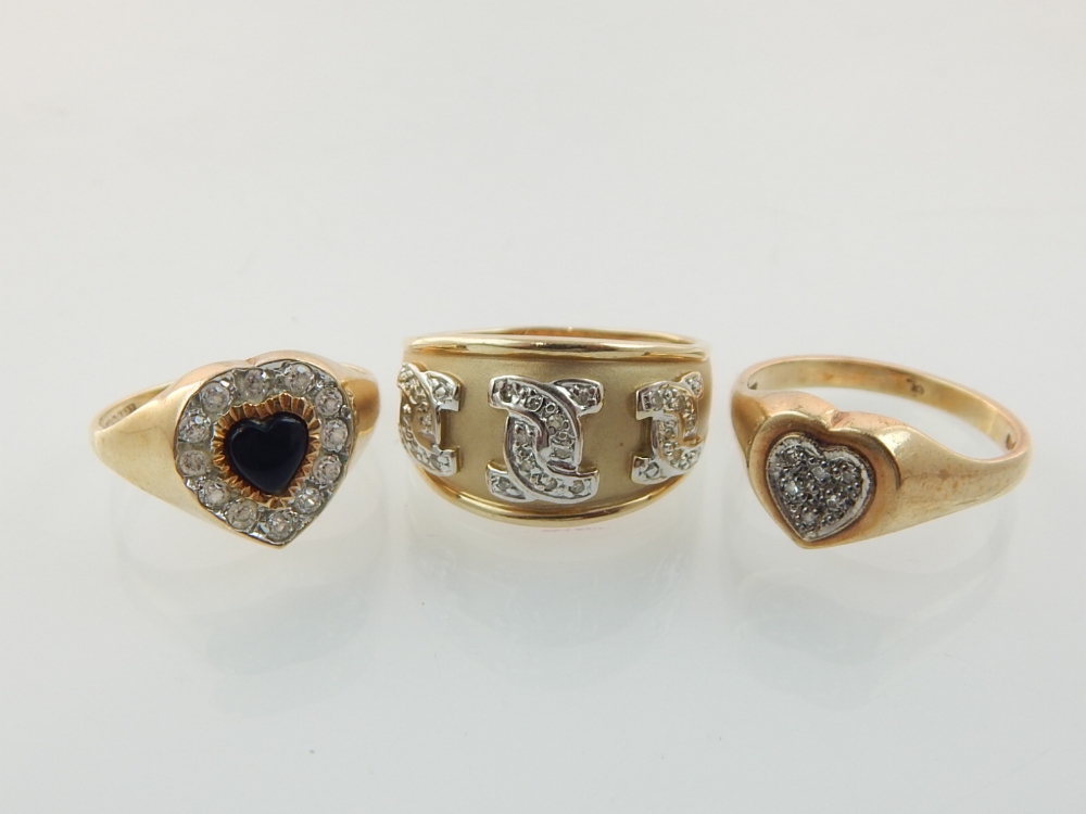 Two 9ct gold heart cluster rings and another 9ct gold ring.