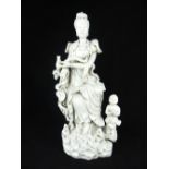 Chinese Blanc De Chine figure of Guan Yin, seated with sceptre and child attendant, 37cm H.