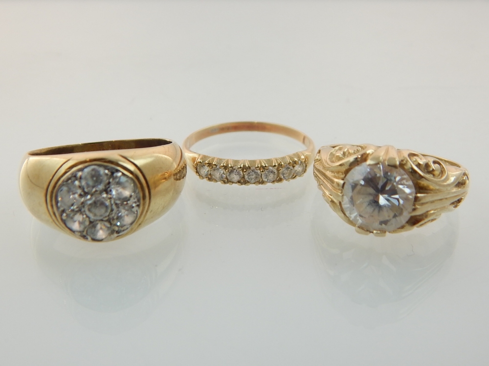 Three 9ct gold and white stone rings.