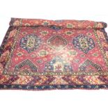 Persian rug, with an arrangement of seriated guls on a madder ground and indigo border,