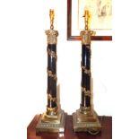 Pair of ebonised and gilt metal table lamps, with stepped square bases,