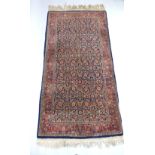 Kashan blue ground rug with dense floral field within a wide triple border,