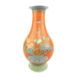 Chinese coral glazed baluster vase decorated with vases of flowers, 25 cm H.