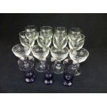 Eight clear glass goblet wine glasses, three mauve glass tots and four other glasses.