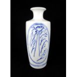 A modern blanc de chine porcelain vase, with blue underglazed landscapes (with mark to base), 22cm