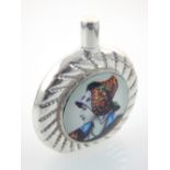 White metal perfume bottle, circular and set with an image of a Dutch woman, 4.5cm